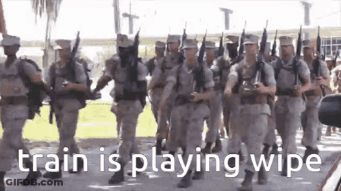 A Group Of Soldiers Marching In A Parade With The Words `` Train Is Playing Wipe '' On The Bottom . GIF