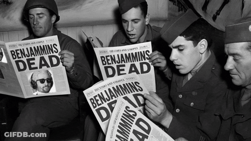 A Group Of Soldiers Reading Benjamins Dead Newspapers GIF