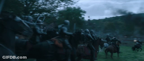 A Group Of Soldiers Riding Horses In A Field With Trees In The Background GIF