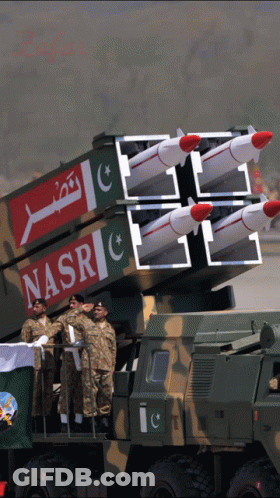 A Group Of Soldiers Stand In Front Of A Military Vehicle With Nasr Written On The Side GIF