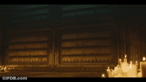 A Group Of Soldiers Standing In A Dark Room With Candles GIF