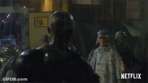 A Group Of Soldiers Standing In Front Of A Netflix Sign GIF
