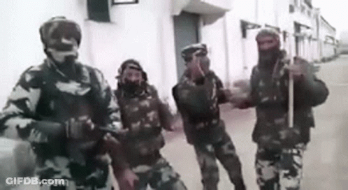 A Group Of Soldiers Standing Next To Each Other On A Street . GIF