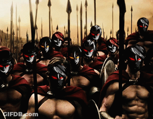 A Group Of Spartan Warriors Wearing Masks And Shields GIF
