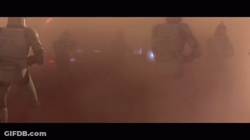 A Group Of Storm Trooper Soldiers Are Walking Through A Foggy Field . GIF