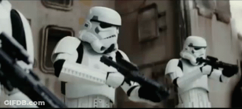A Group Of Stormtroopers Are Holding Their Guns In A Line GIF