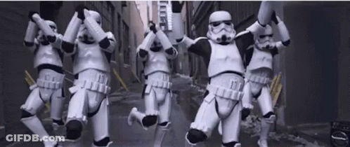 A Group Of Stormtroopers Are Jumping In The Air In A Street . GIF