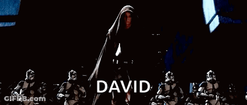 A Group Of Stormtroopers Are Standing In A Dark Room With A Man In A Cape Standing In The Middle . GIF