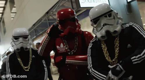 A Group Of Stormtroopers Wearing Adidas Jackets And Gold Chains GIF