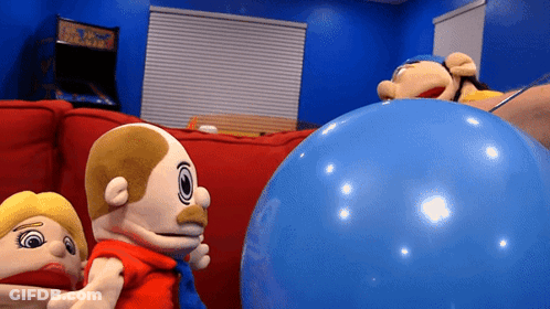 A Group Of Stuffed Animals Are Playing With A Large Blue Ball GIF