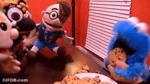 A Group Of Stuffed Animals Are Playing With Cookies On A Table GIF