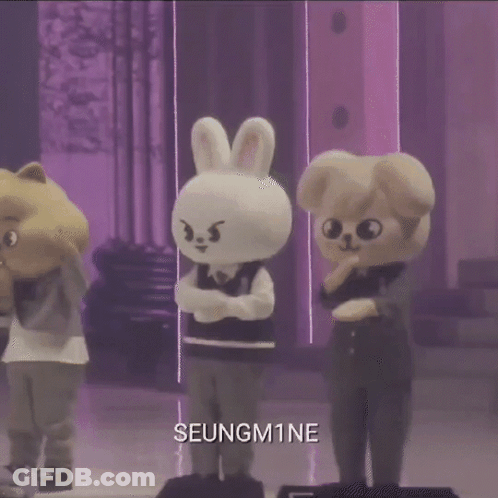 A Group Of Stuffed Animals Standing Next To Each Other On A Stage With The Name Seungm1ne On The Bottom . GIF