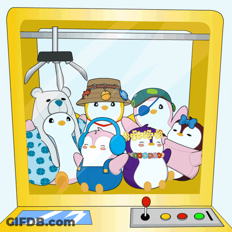 A Group Of Stuffed Penguins Are In A Machine GIF