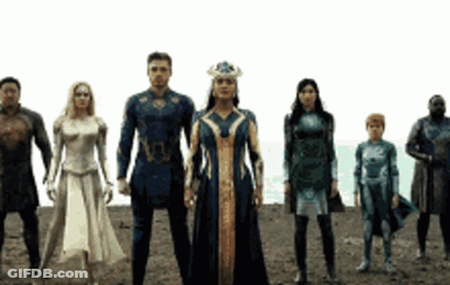 A Group Of Superhero Characters Standing Next To Each Other In A Line . GIF