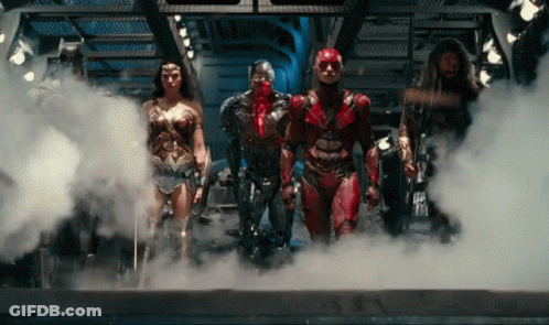 A Group Of Superheroes Standing In A Room With Smoke Coming Out Of Them GIF