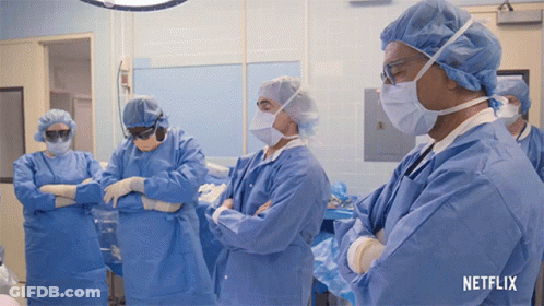 A Group Of Surgeons In An Operating Room With A Netflix Logo GIF