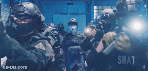A Group Of Swat Officers In A Dark Room GIF