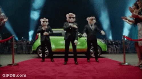 A Group Of Teddy Bears Are Dancing On A Red Carpet In Front Of A Green Car . GIF