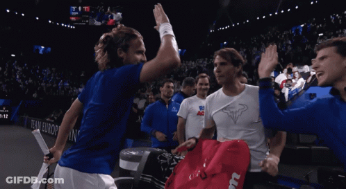 A Group Of Tennis Players High Five Each Other In Front Of A Scoreboard That Says Team Europe GIF