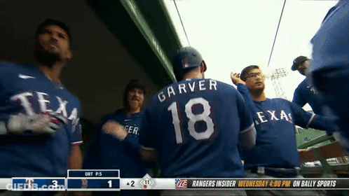 A Group Of Texas Rangers Players Standing In The Dugout GIF