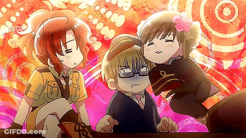 A Group Of Three Anime Characters Are Standing Next To Each Other On A Table . GIF