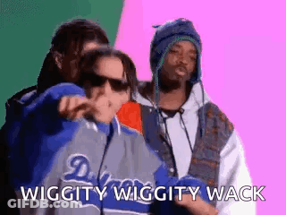 A Group Of Three Men Are Standing Next To Each Other And One Of Them Is Wearing A Jacket That Says Dodgers On It . GIF