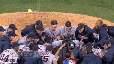 A Group Of Tigers Baseball Players Huddle Together GIF
