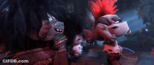 A Group Of Trolls Are Standing Next To Each Other In A Dark Room And Singing . GIF
