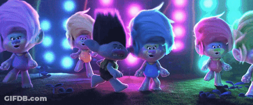 A Group Of Trolls Are Standing Next To Each Other On A Stage Dancing . GIF