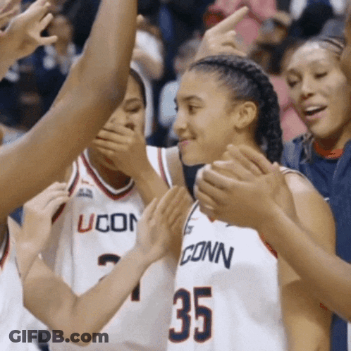 A Group Of Uconn Basketball Players Are Clapping Together GIF
