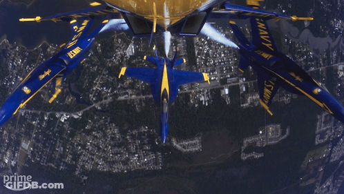 A Group Of Us Navy Planes Flying In Formation GIF