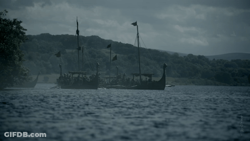 A Group Of Viking Boats Are Floating In A Lake GIF