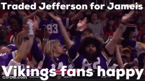 A Group Of Vikings Fans Are Raising Their Arms In The Air . GIF