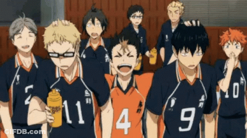 A Group Of Volleyball Players Are Standing Next To Each Other In A Gym . GIF