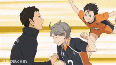 A Group Of Volleyball Players Are Standing Next To Each Other On A Court And One Of Them Is Jumping In The Air . GIF