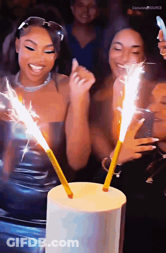 A Group Of Women Are Celebrating A Birthday With Sparklers And The Words Coco Jones Source In The Corner GIF