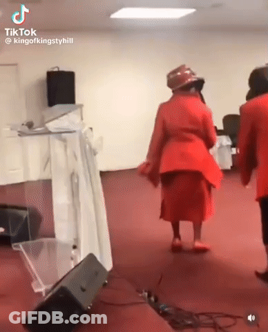 A Group Of Women Are Dancing In A Church . GIF