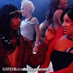A Group Of Women Are Dancing In A Club And One Of Them Is Saying Enjoy Yourself GIF