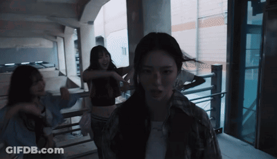 A Group Of Women Are Dancing In A Dark Room With The Number 11 In The Background GIF