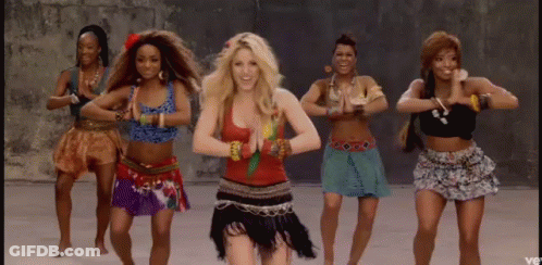 A Group Of Women Are Dancing In A Line With One Woman Wearing A Red Top . GIF