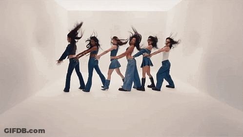A Group Of Women Are Dancing In A Line With Their Hair Flying In The Air GIF