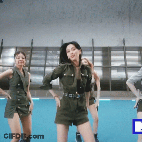 A Group Of Women Are Dancing In A Room With A Blue Rectangle In The Middle GIF