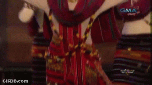 A Group Of Women Are Dancing In A Traditional Costume . GIF