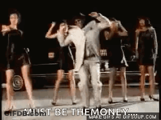 A Group Of Women Are Dancing In Front Of A Car With The Words `` Must Be The Money '' Written Above Them . GIF