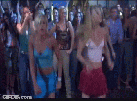 A Group Of Women Are Dancing In Front Of A Crowd Of People . GIF