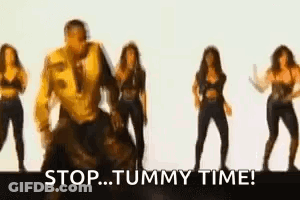 A Group Of Women Are Dancing In Front Of A Man Who Is Dancing . GIF