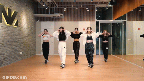 A Group Of Women Are Dancing In Front Of A Mirror In A Dance Studio With A Sign That Says N2 On It GIF