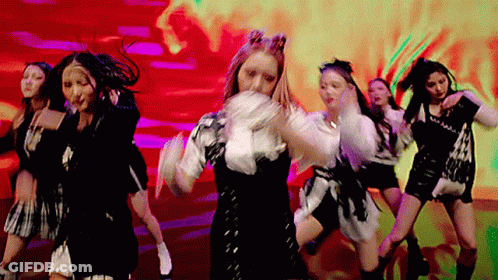 A Group Of Women Are Dancing In Front Of A Red Background . GIF