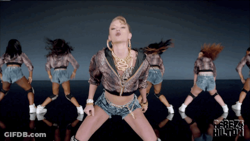 A Group Of Women Are Dancing In Front Of A Screen That Says ' Freak Hilton ' On It GIF
