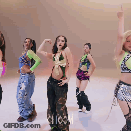 A Group Of Women Are Dancing In Front Of A Sign That Says ' Show ' GIF